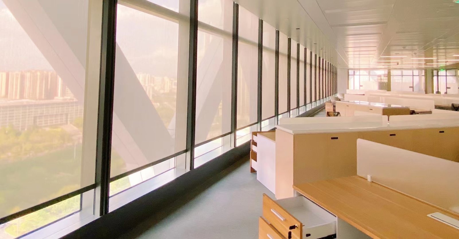 Window shading system installed along a lobby-style commercial facade