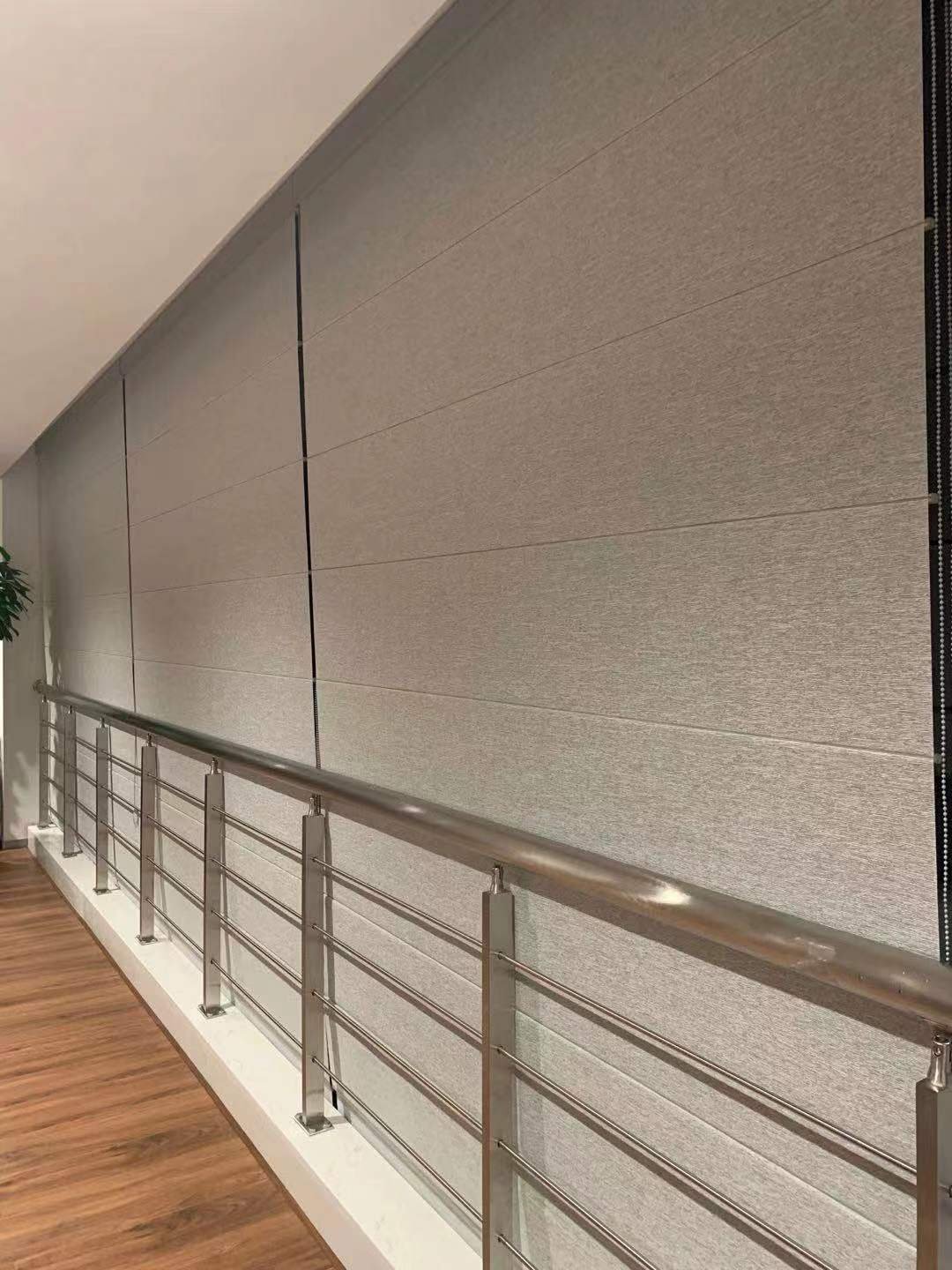 Light filtering roller blinds detail along a commercial corridor window