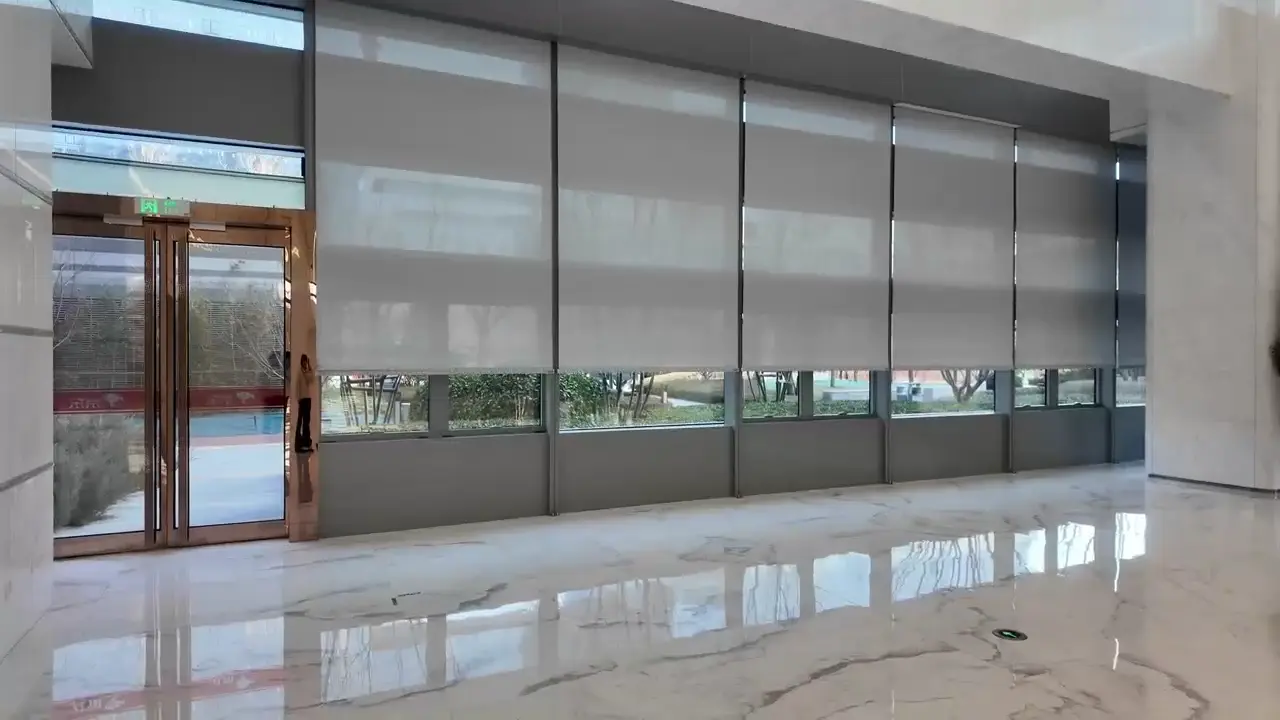 JD.com Headquarters Motorized Shading Project — Beijing Yizhuang Wide bank of roller shades across a public-space façade.